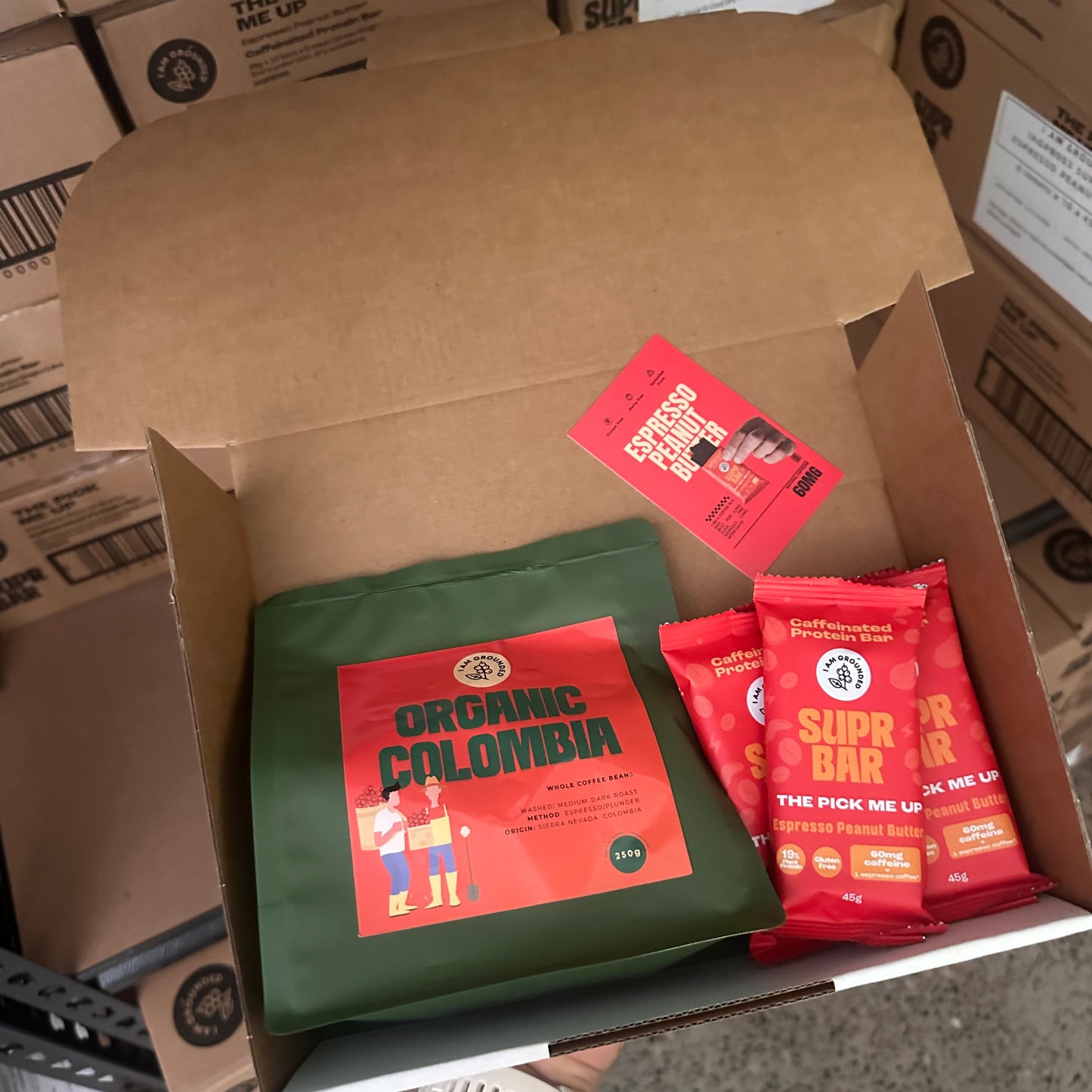Box with red and green packages on a concrete floor