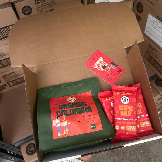 Box with red and green packages on a concrete floor